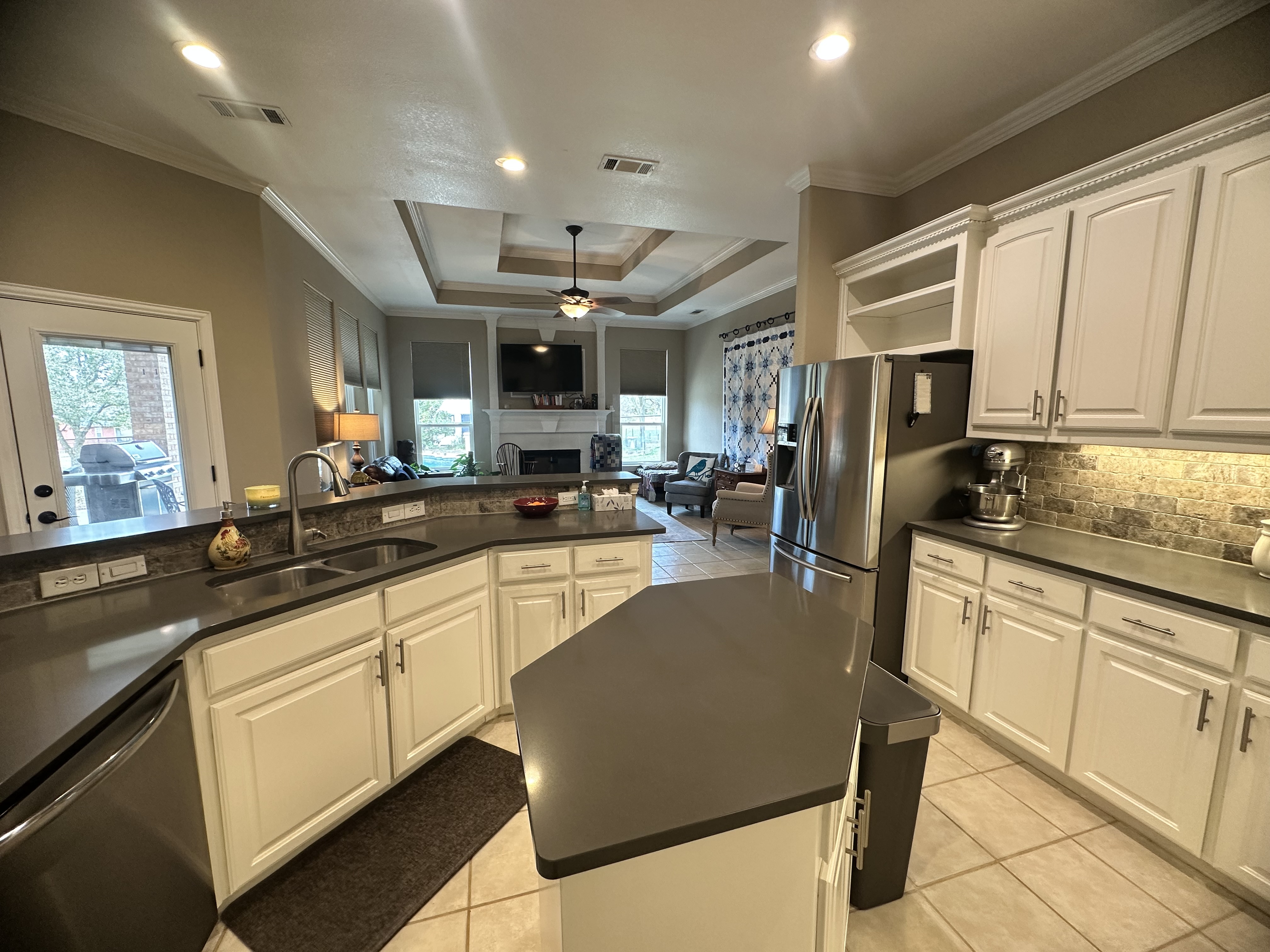 3588 Heritage Trail Celina, TX 75009 - Photo 7 of 19 a kitchen with stainless steel appliances granite countertop a refrigerator a sink dishwasher a stove and white cabinets with wooden floor