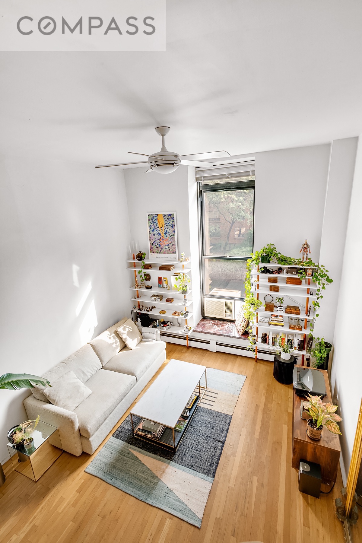 250 Mercer Street, Unit C309 Manhattan, NY 10012 - Photo 3 of 8 a living room with furniture and a flat screen tv
