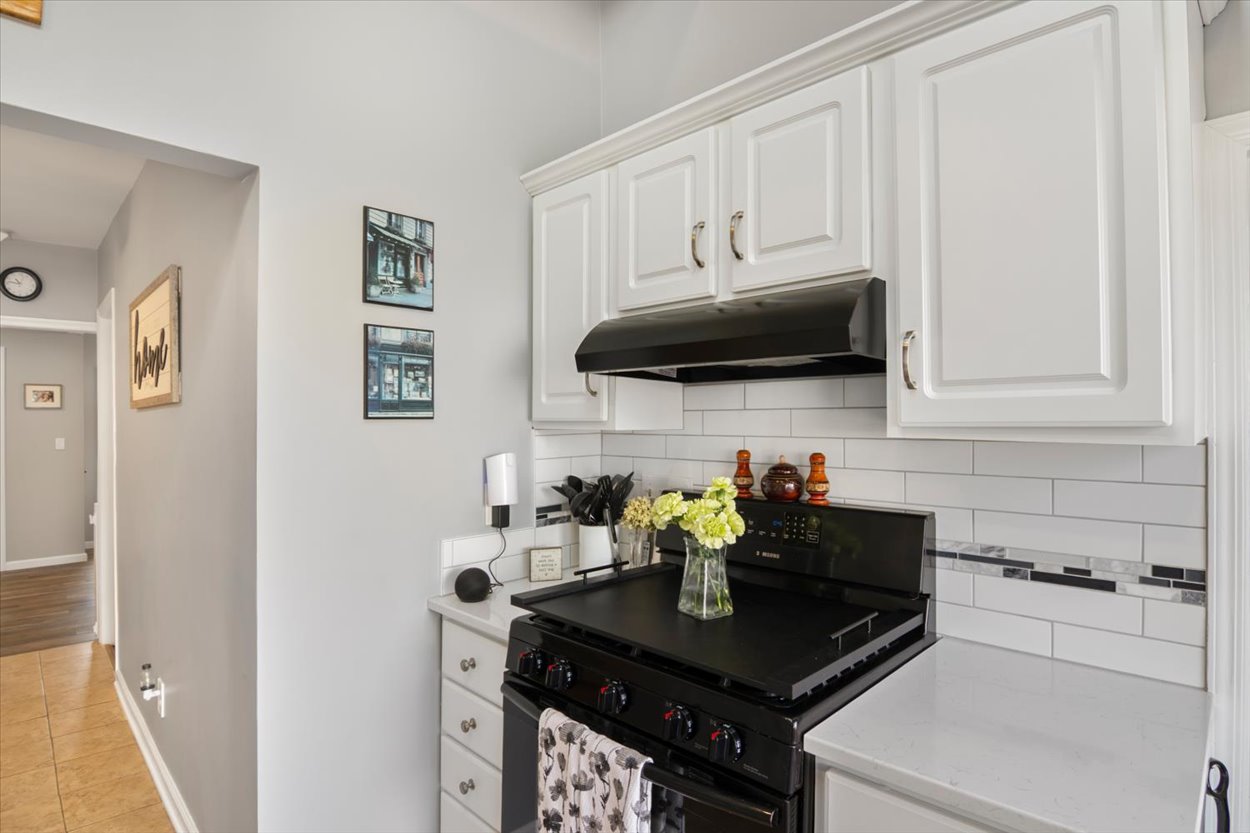 107 Kingston Road Parsippany, NJ 07054 - Photo 8 of 43 a kitchen with stainless steel appliances a sink a stove white cabinets and a refrigerator