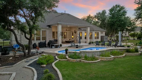 a view of a house with swimming pool and sitting area