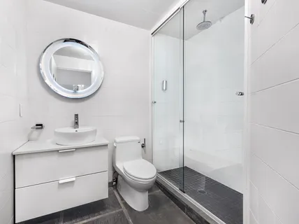a bathroom with a toilet a sink and a mirror