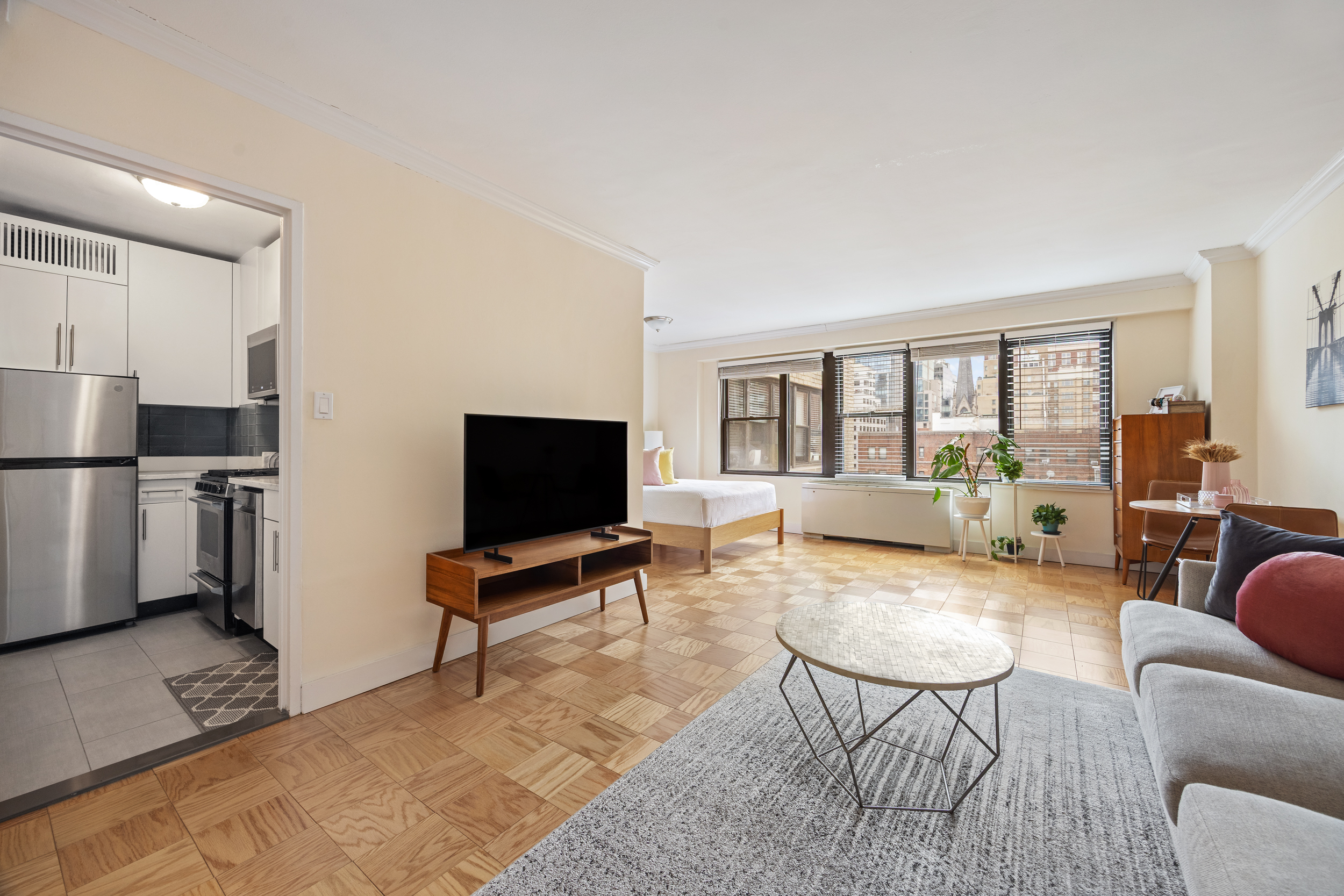 120 East 90th Street, Unit 7A Manhattan, NY 10128 - Photo 1 of 8 a living room with furniture and a flat screen tv