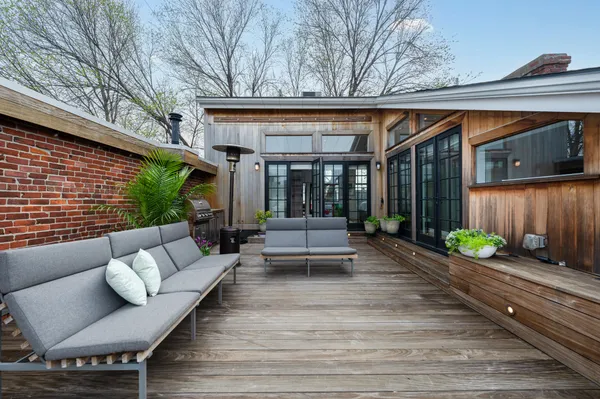 a view of house with backyard and outdoor seating