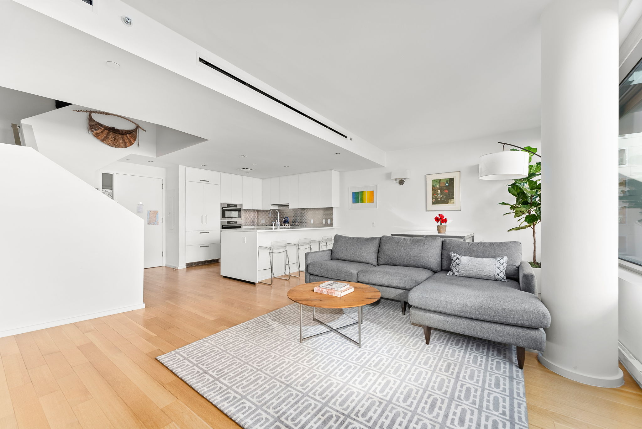 425 West 53rd Street, Unit 416 Manhattan, NY 10019 - Photo 4 of 19 a living room with furniture and a couch