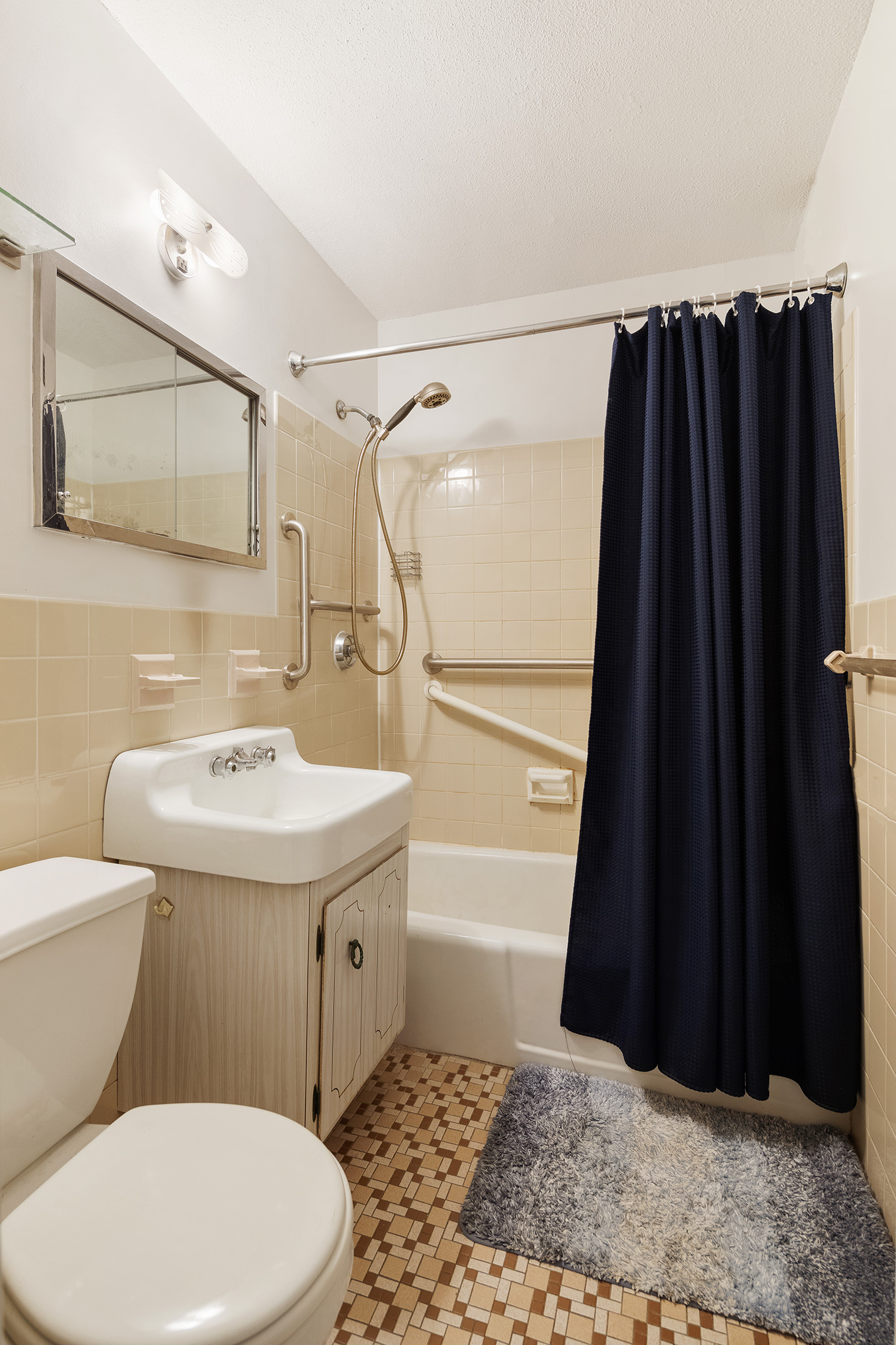 75 Henry Street, Unit 25J Brooklyn, NY 11201 - Photo 10 of 15 a bathroom with a sink a toilet a vanity and shower
