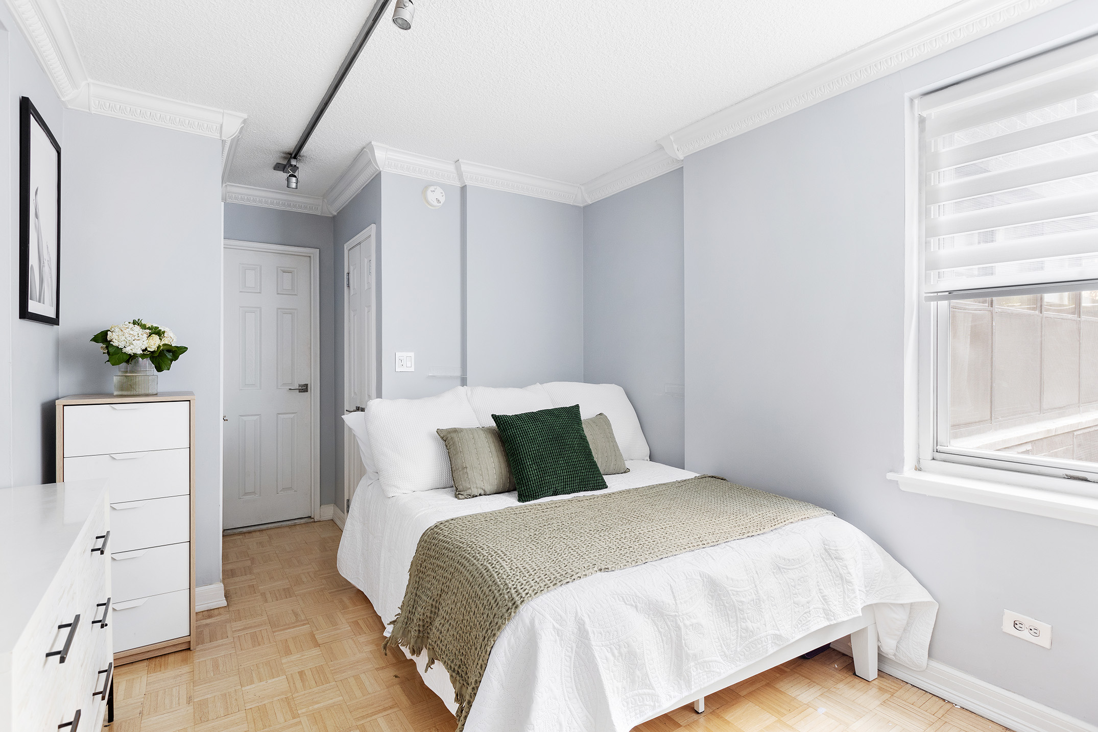 200 East 24th Street, Unit 201 Manhattan, NY 10010 - Photo 4 of 7 a bedroom with a bed and a window