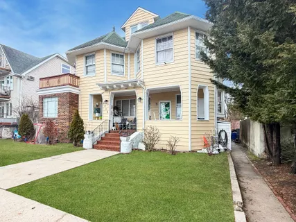 a front view of house with yard and outdoor seating