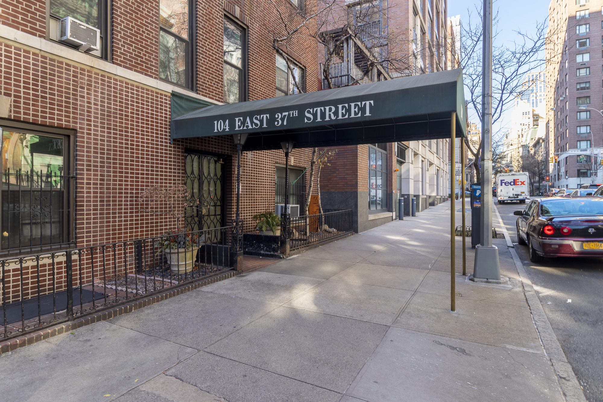 104 East 37th Street, Unit 5C Manhattan, NY 10016 - Photo 6 of 9 a view of a building with parking space and a car parked on the road