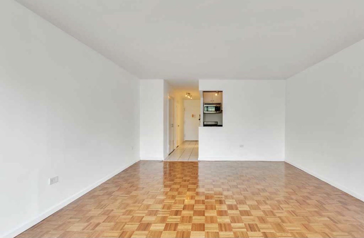 222 West 14th Street, Unit 5D Manhattan, NY 10011 - Photo 3 of 9 a view of empty room with wooden floor