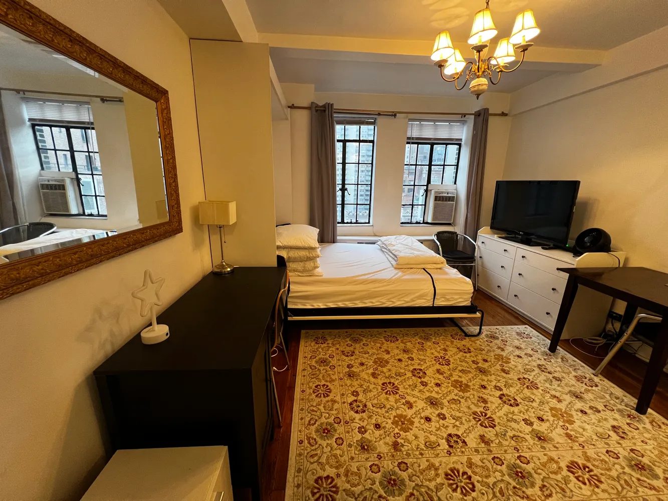 a bedroom with a bed and a flat screen tv