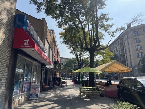 834 Riverside Drive, Unit E6 Manhattan, NY 10032 - Photo 12 of 22 a patio with a table and chairs under an umbrella