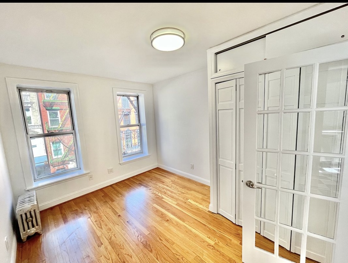 80 East 7th Street, Unit 4C Manhattan, NY 10003 - Photo 2 of 7 a view of an empty room with window and wooden floor