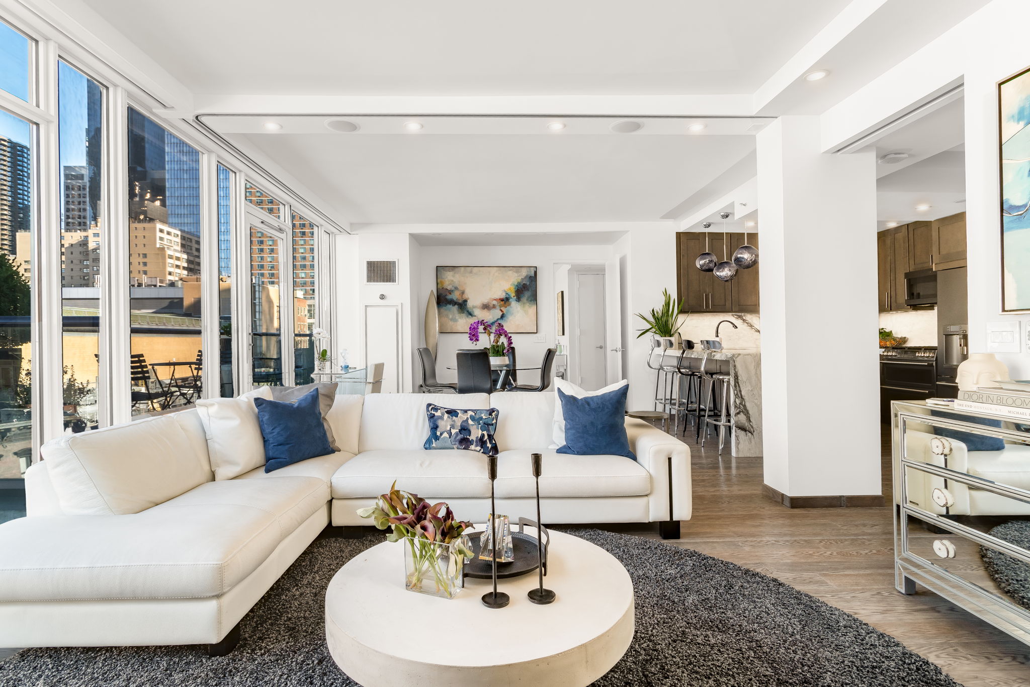 350 West 53rd Street, Unit PHB Manhattan, NY 10019 - Photo 3 of 34 a living room with furniture and a wooden floor