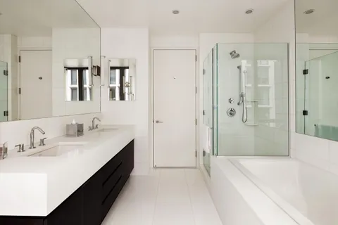 a spacious bathroom with a tub sink and shower