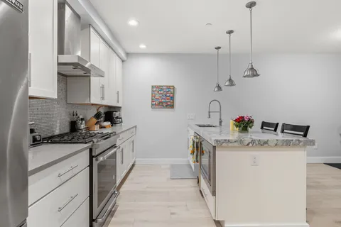 a kitchen with a sink stove and cabinets