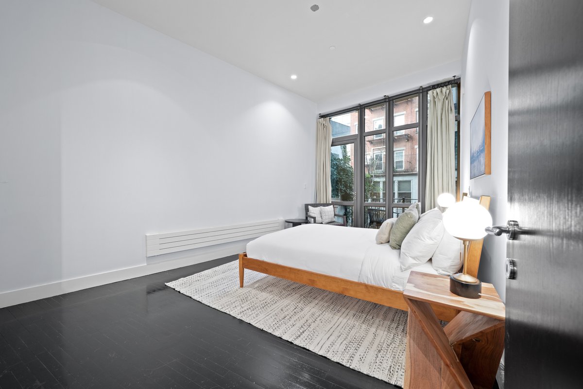 133 West 14th Street, Unit 1 Manhattan, NY 10011 - Photo 10 of 17 a bedroom with a bed and window