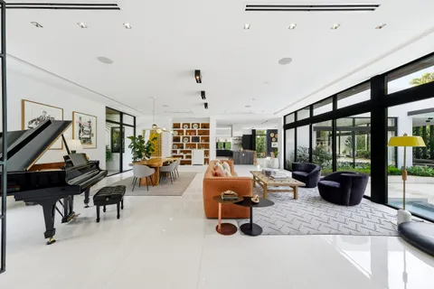 a living room with furniture and a floor to ceiling window