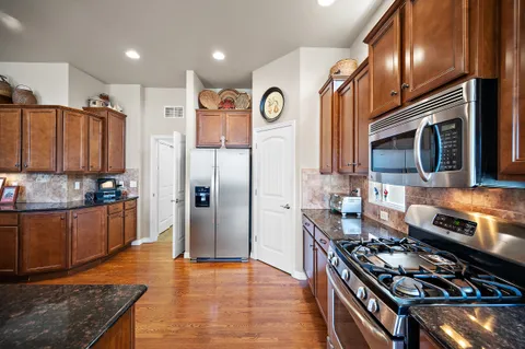 a bathroom with a granite countertop sink a large mirror and a shower