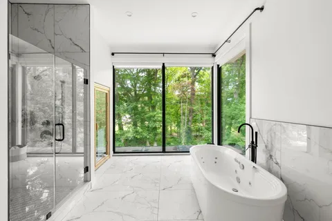 a bathroom with a bathtub and a large window