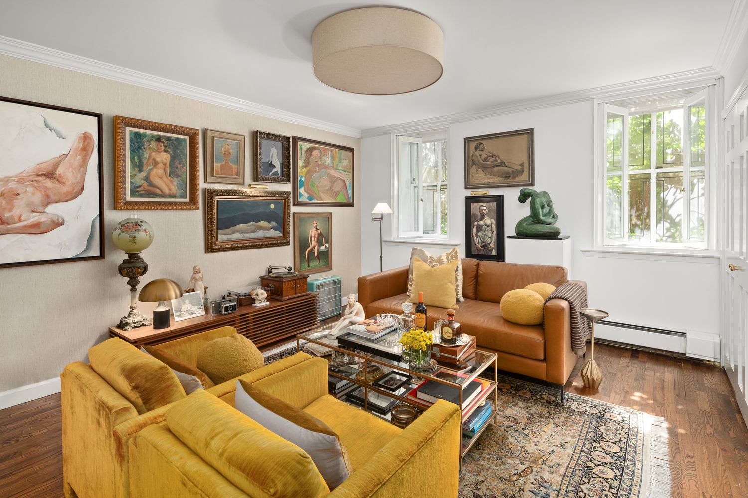 a living room with furniture fireplace and a window