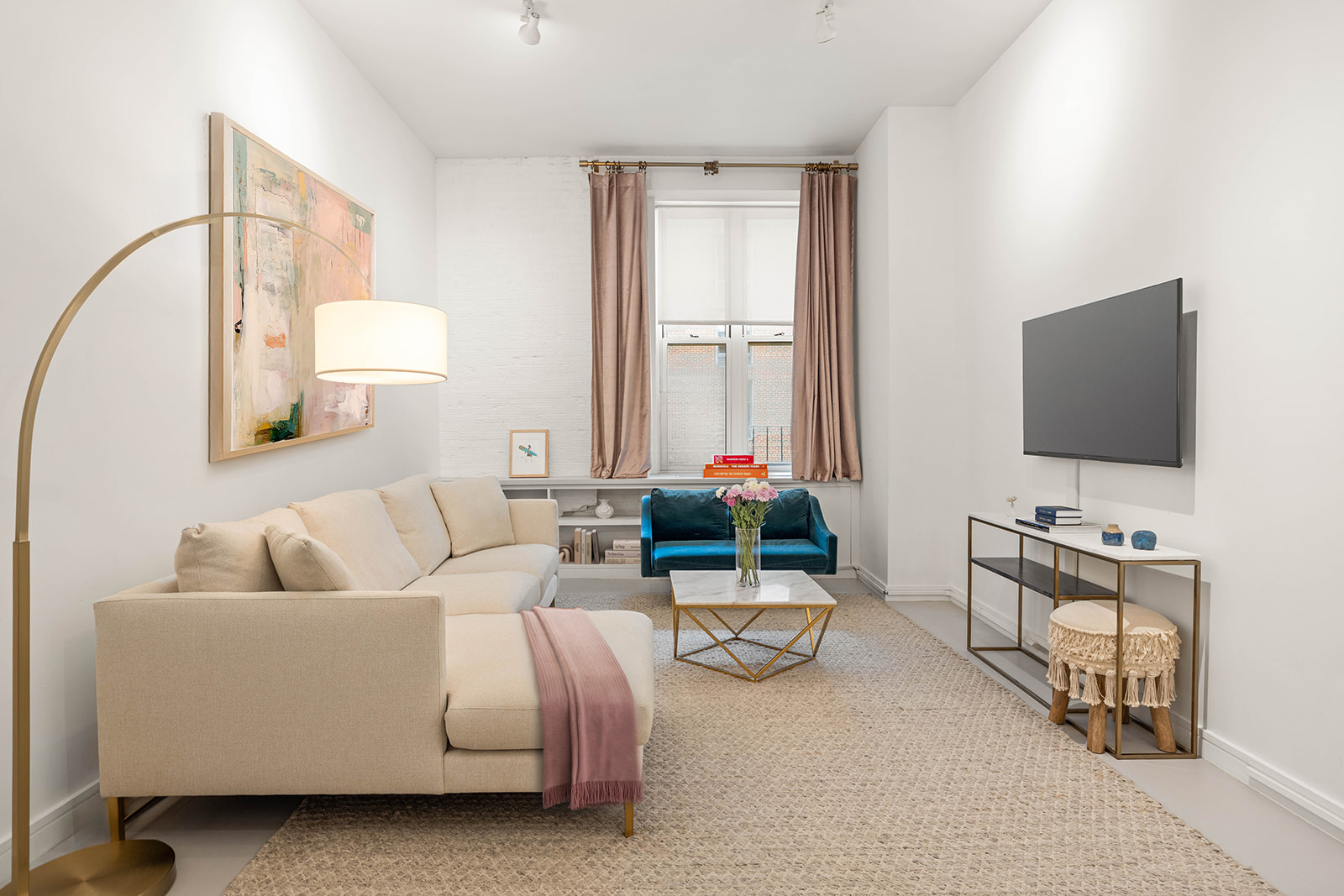 23 Waverly Place, Unit 3Y Manhattan, NY 10003 - Photo 2 of 12 a living room with furniture and a flat screen tv