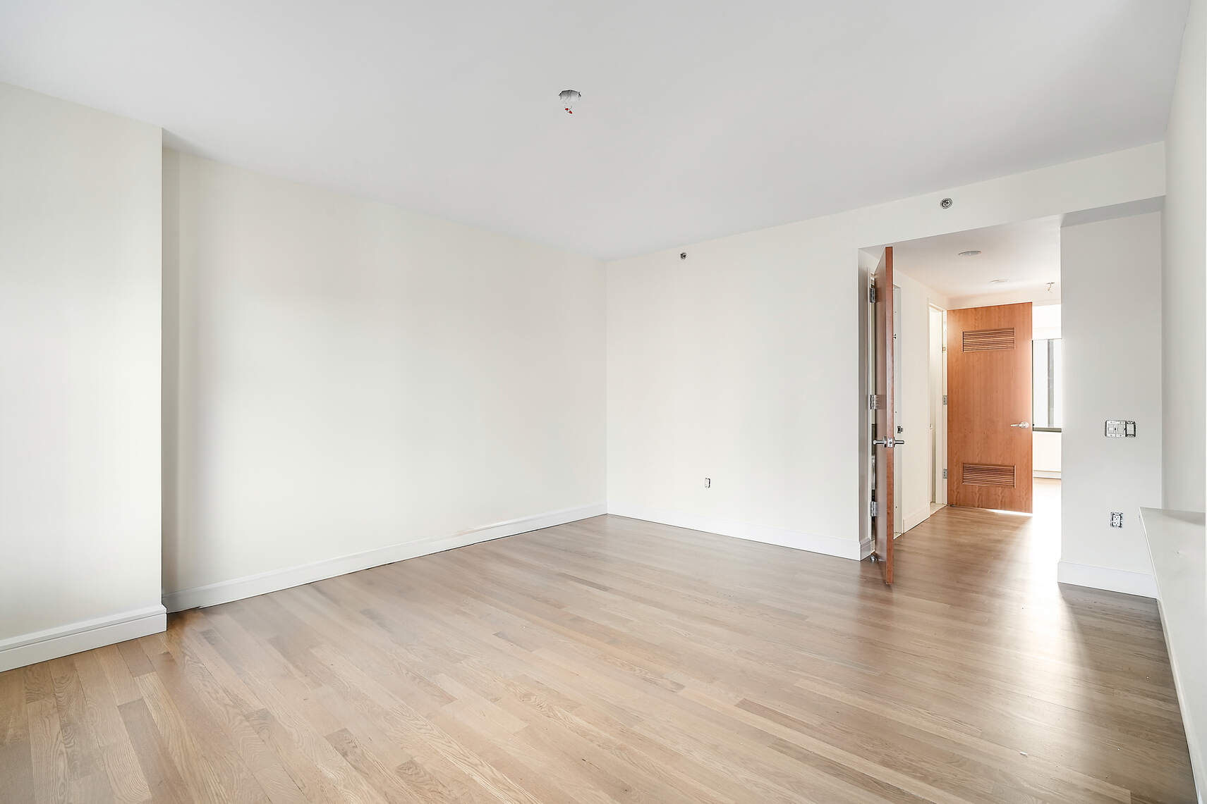 454 West 54th Street, Unit 3A Manhattan, NY 10019 - Photo 6 of 13 a view of an empty room with wooden floor