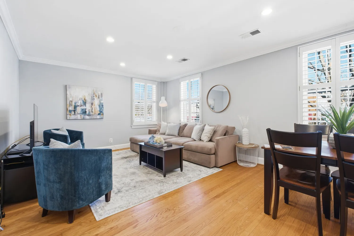 a living room with fireplace furniture and a potted plant