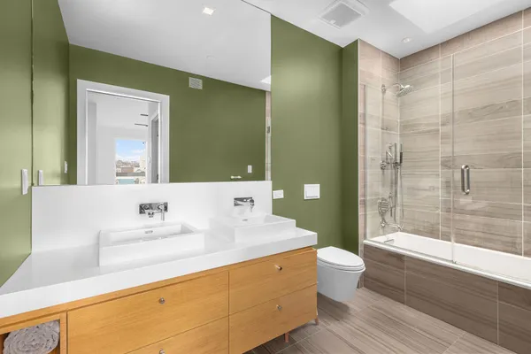a bathroom with a sink a toilet and shower