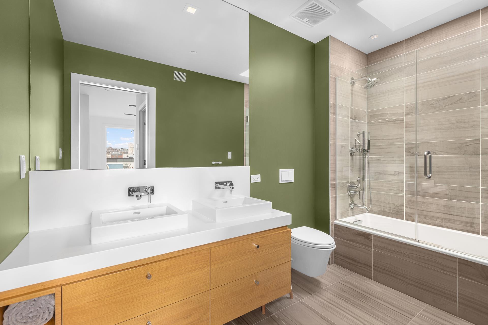 800 Dean Street, Unit PH Brooklyn, NY 11238 - Photo 6 of 11 a bathroom with a sink a toilet and shower