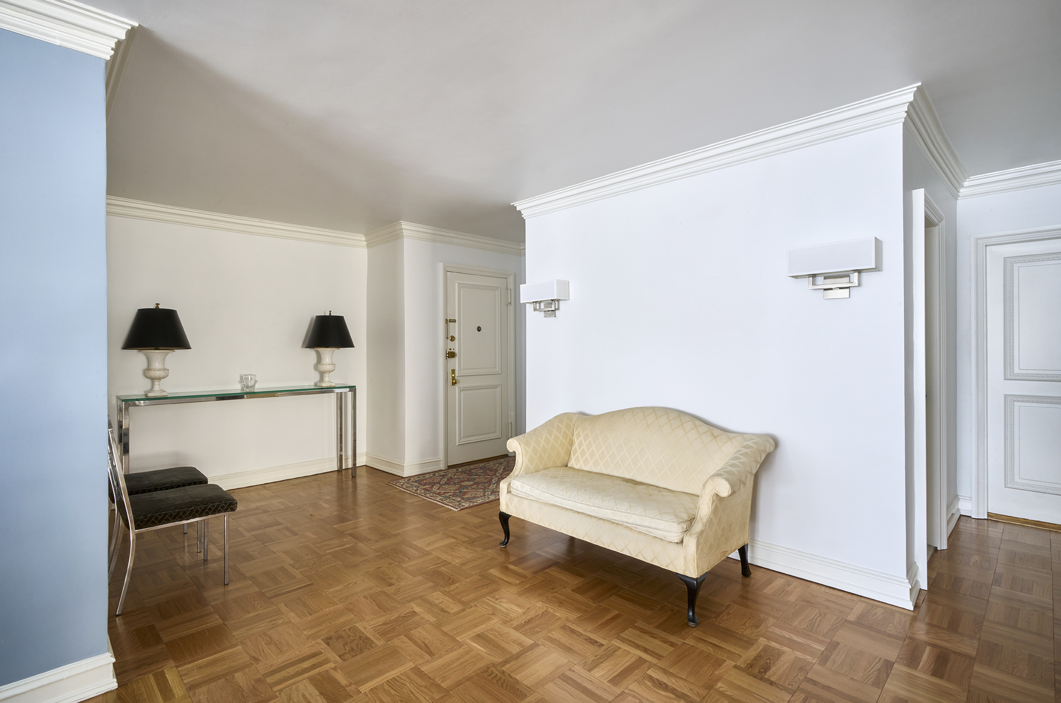 650 Park Avenue, Unit 10D Manhattan, NY 10065 - Photo 4 of 11 a living room with a couch and a dresser with wooden floor