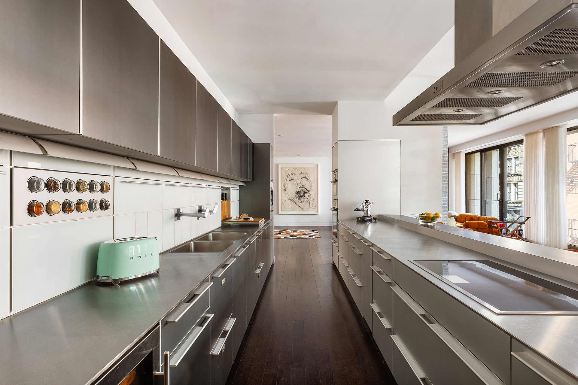 25 Bond Street, Unit 3E Manhattan, NY 10012 - Photo 8 of 23 a kitchen with counter top space a sink and stainless steel appliances