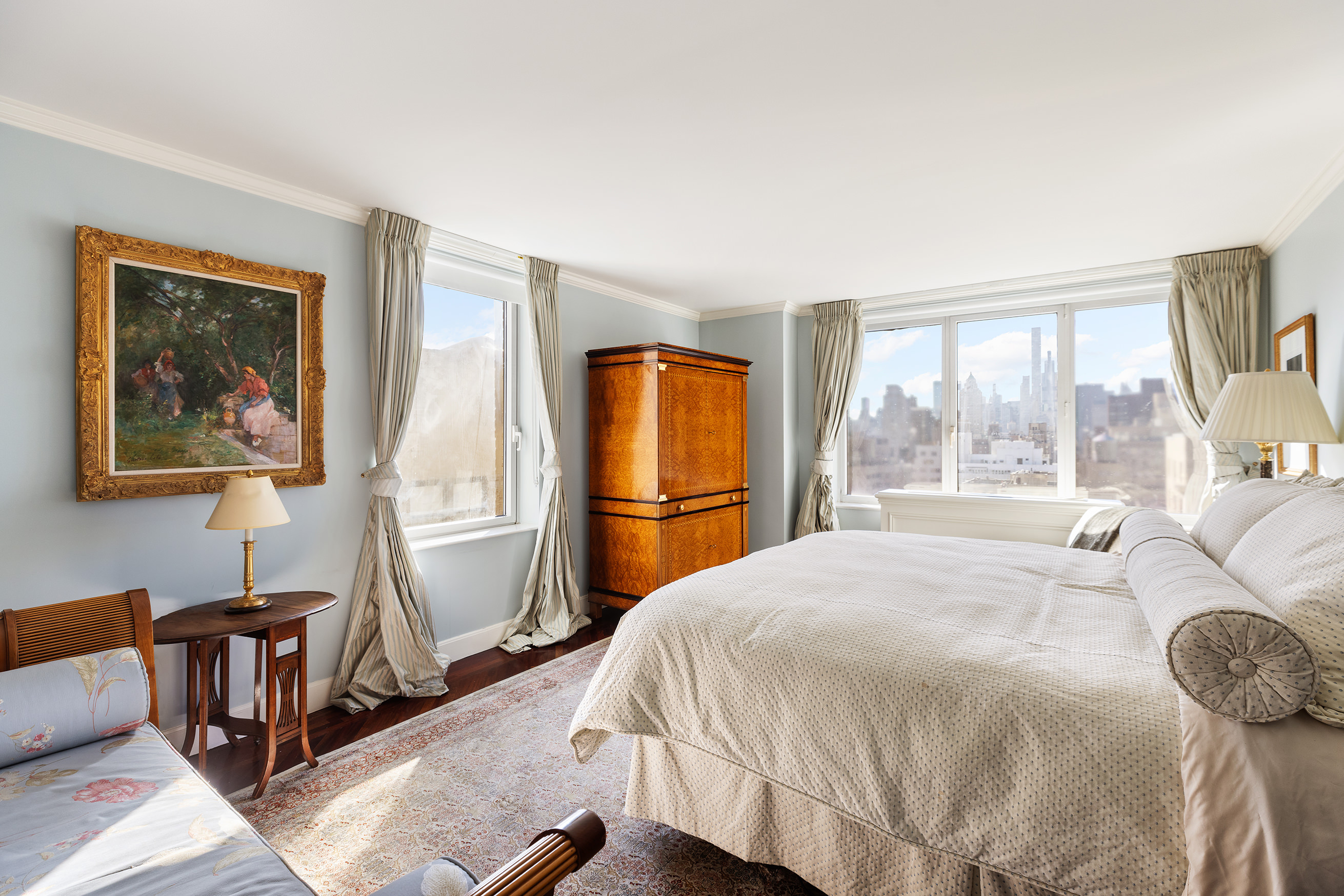 1049 5th Avenue, Unit 17A Manhattan, NY 10028 - Photo 8 of 11 a bedroom with a bed and wooden floor