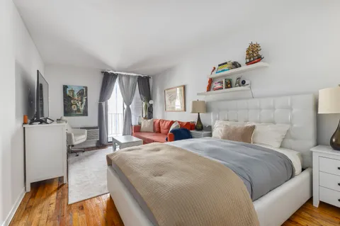 a bedroom with bed and window