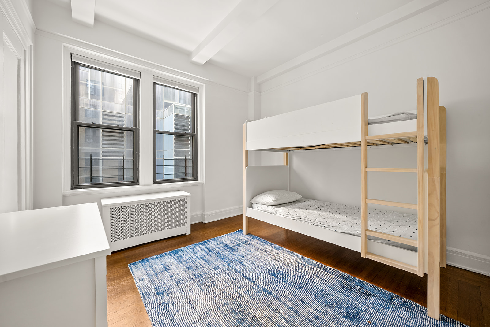152 West 58th Street, Unit 6CD Manhattan, NY 10019 - Photo 5 of 9 a bedroom with a bed and wooden floor