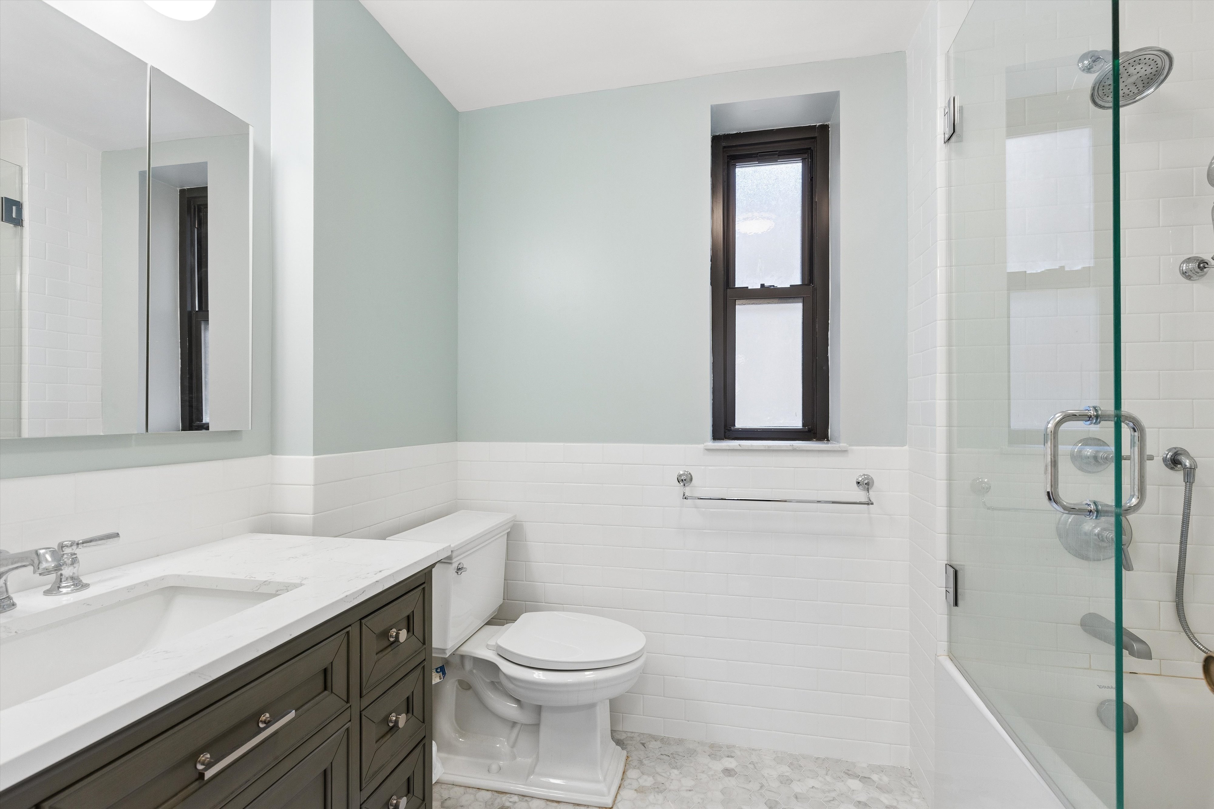 444 East 52nd Street, Unit 3C Manhattan, NY 10022 - Photo 9 of 19 a bathroom with a granite countertop sink toilet and shower