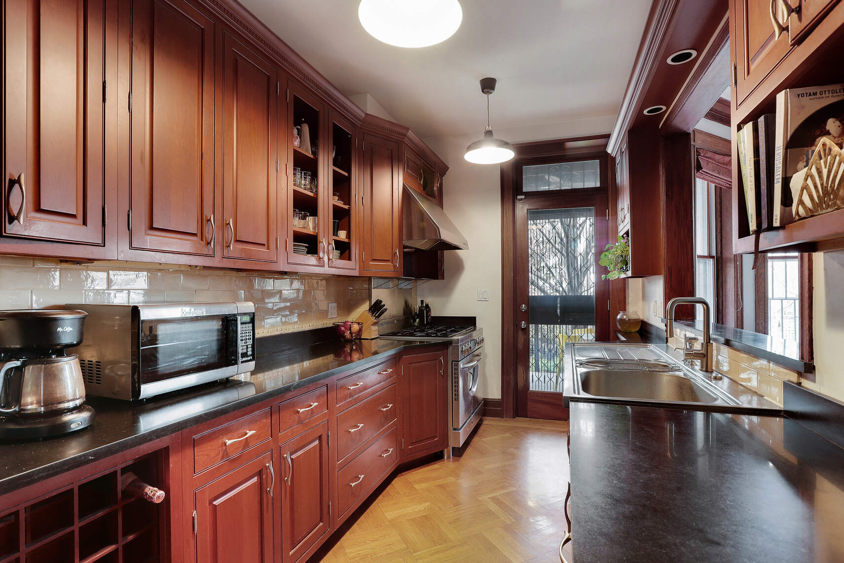 261 Fenimore Street Brooklyn, NY 11225 - Photo 8 of 21 a kitchen with stainless steel appliances granite countertop a sink stove and wooden cabinets