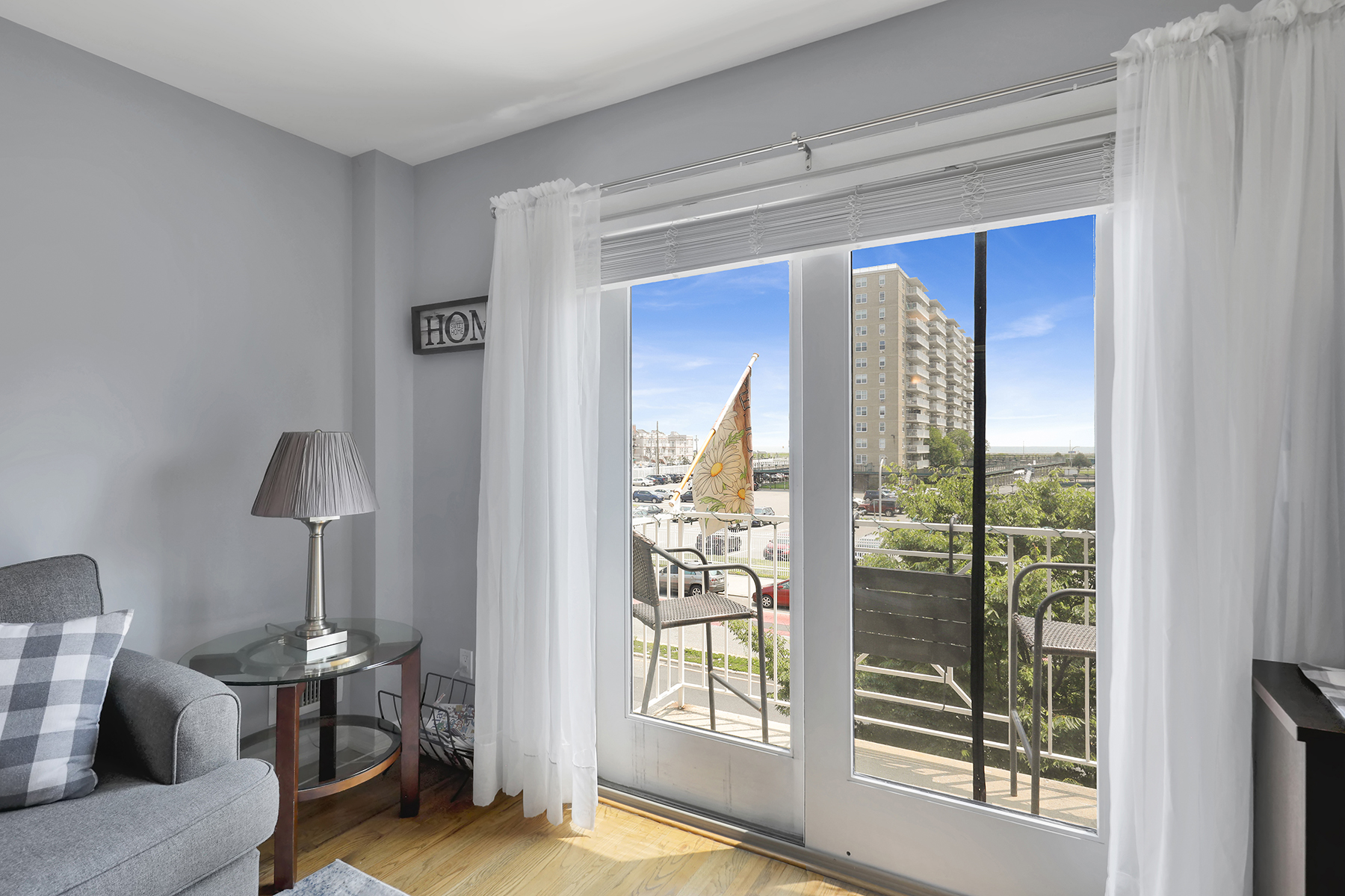 102-20 Rockaway Beach Boulevard, Unit 3C Queens, NY 11694 - Photo 16 of 36 a living room with furniture and a window