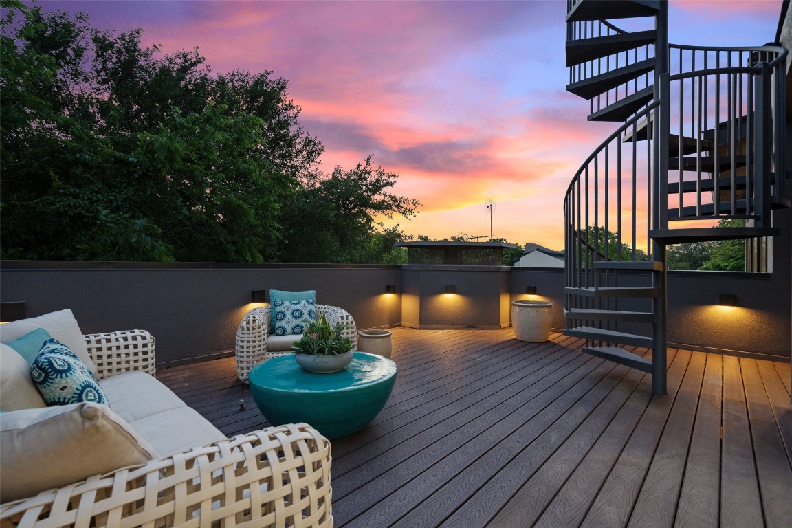 1207 East 13th Street Austin, TX 78702 - Photo 34 of 39 a view of a deck with couches table and chairs with wooden floor and fence