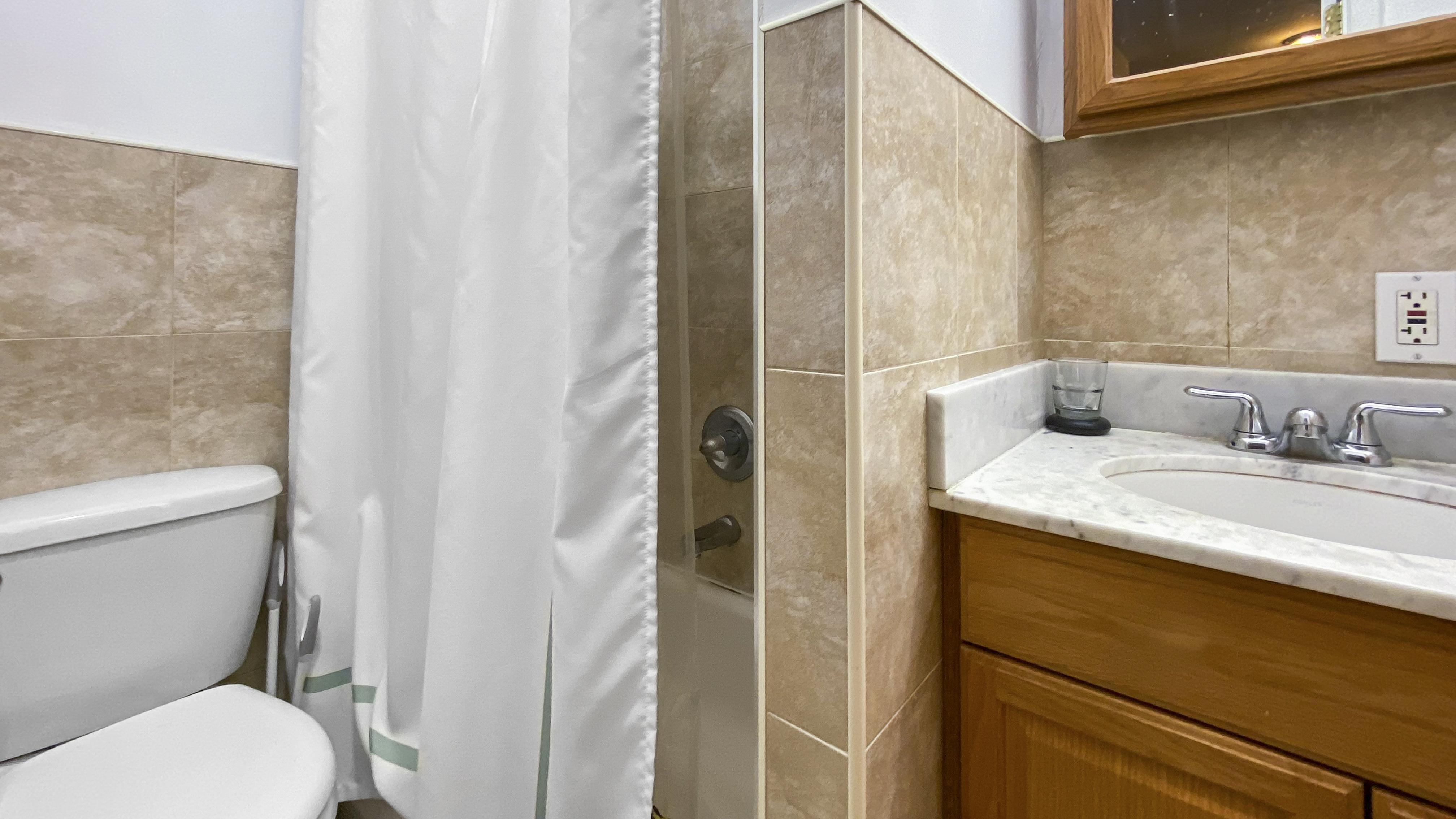 1059 2nd Avenue, Unit 3AB Manhattan, NY 10022 - Photo 7 of 8 a bathroom with a granite countertop sink toilet and shower