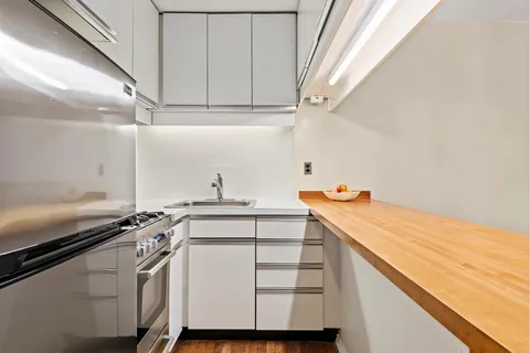 a kitchen with a sink and cabinets
