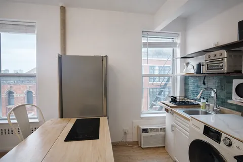a kitchen with a refrigerator and a stove