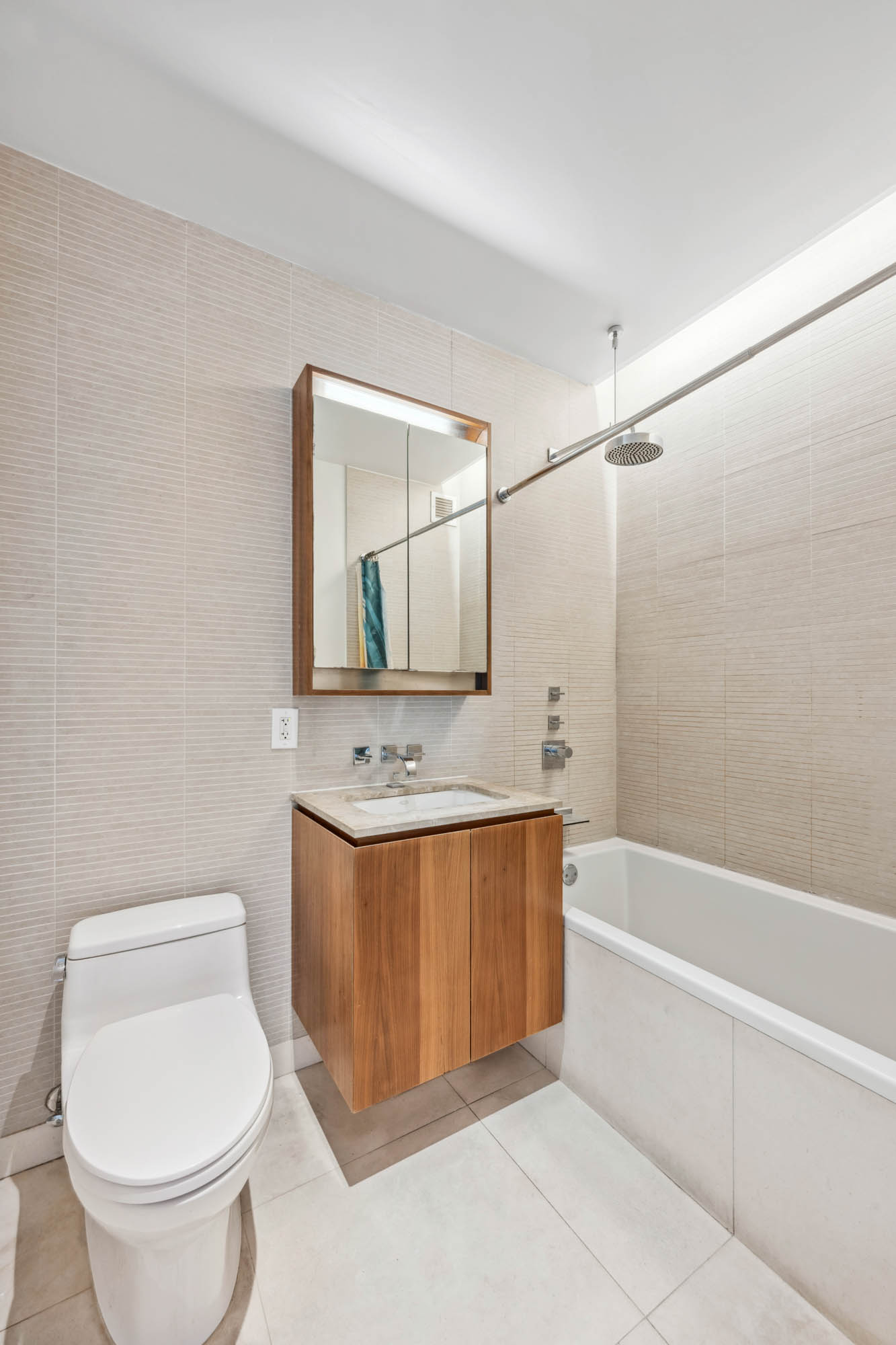 555 West 59th Street, Unit 7E Manhattan, NY 10019 - Photo 6 of 9 a bathroom with a sink a toilet and shower