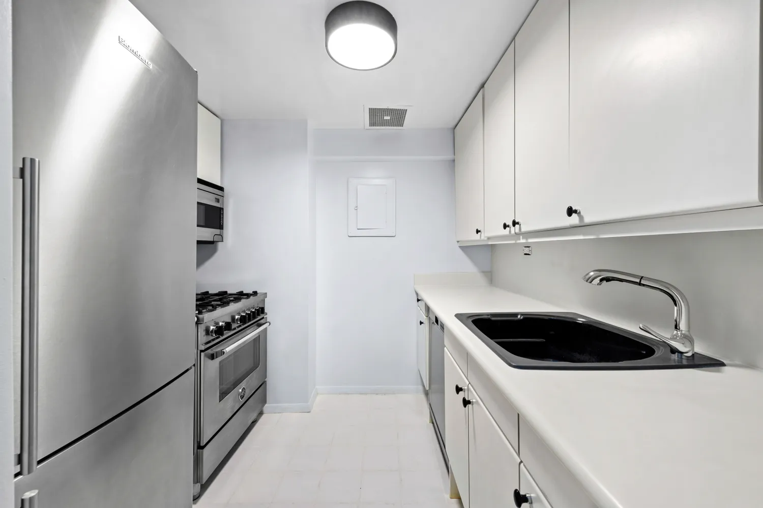 a kitchen with sink and cabinets