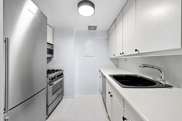 a kitchen with sink and cabinets