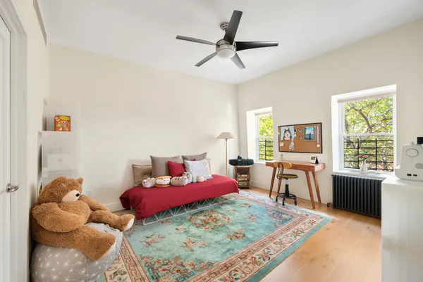 a living room with furniture rug and a window
