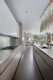 a kitchen with stainless steel appliances granite countertop a stove a sink and a refrigerator