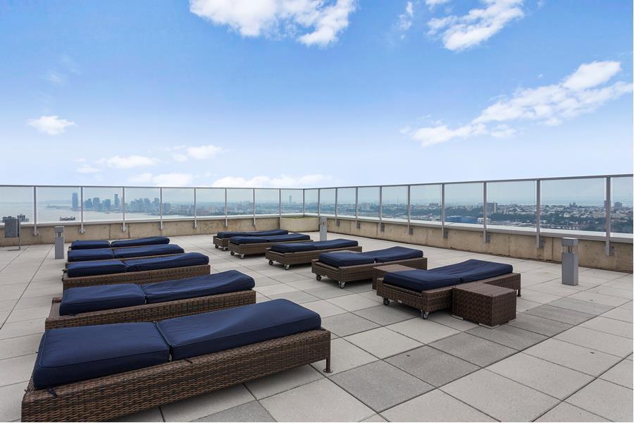 635 West 42nd Street, Unit 12D Manhattan, NY 10036 - Photo 12 of 18 a view of a terrace with couches and sky view