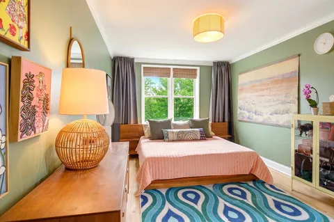 a bedroom with furniture and a window