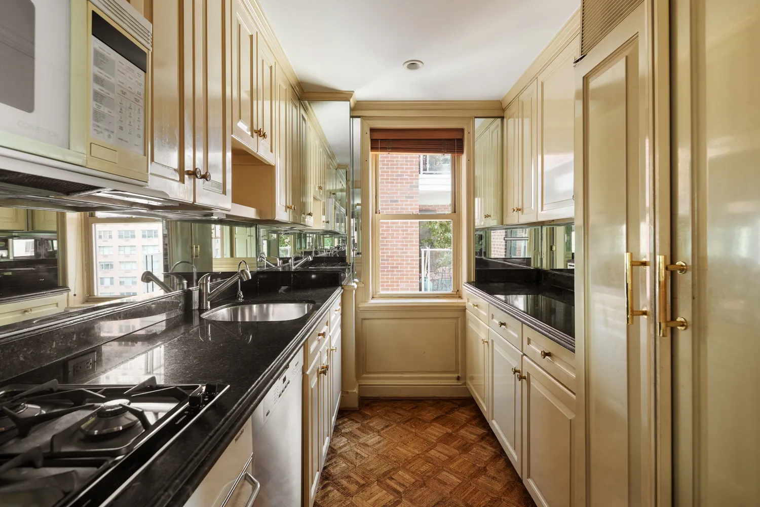 a kitchen with stainless steel appliances a sink stove and cabinets