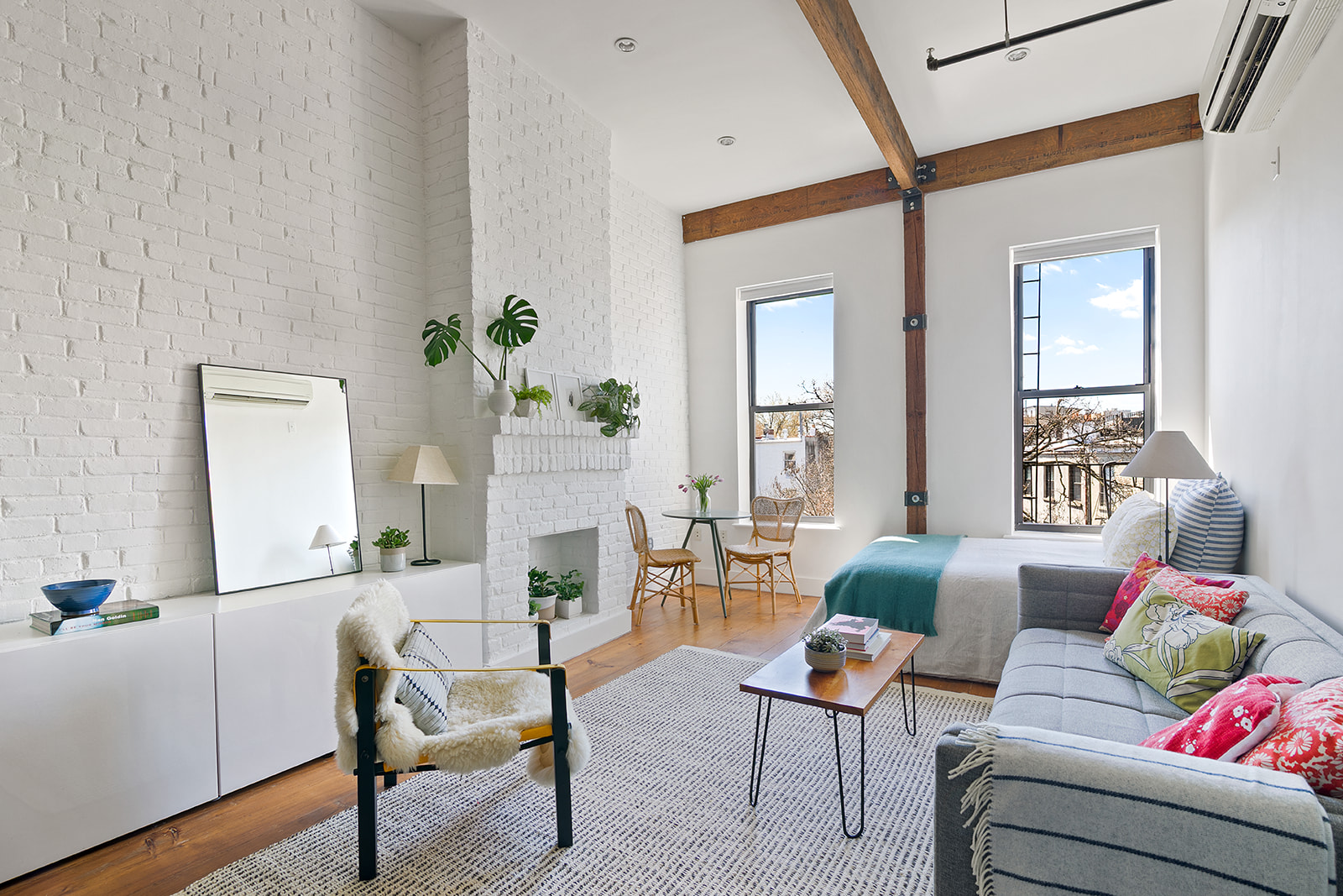 a living room with furniture and a potted plant